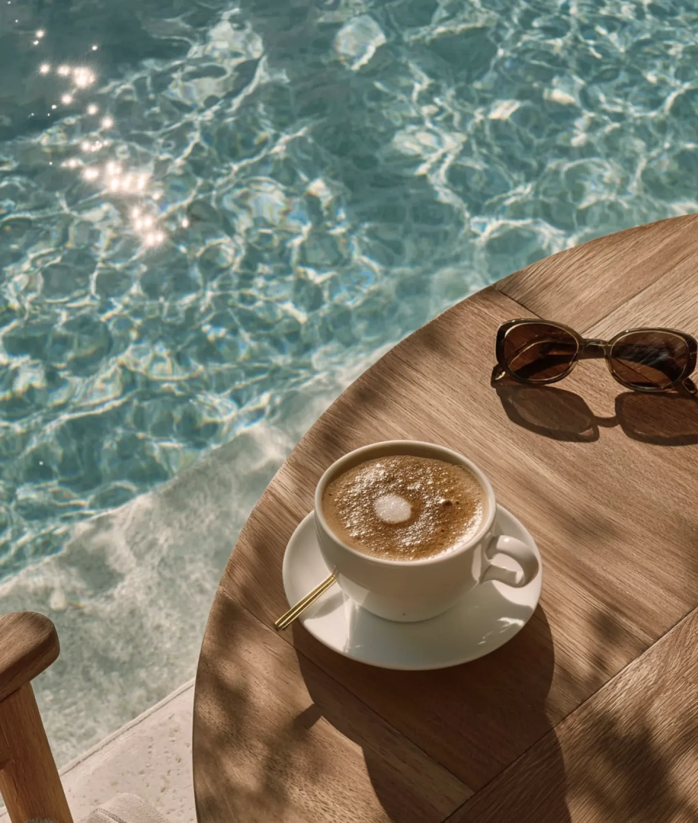 Coffee and sunglasses beside the elevated pool